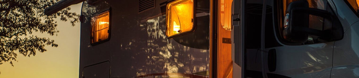 a recreational vehicle parked in the evening.