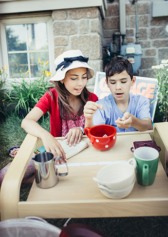 Siblings having a yard sale