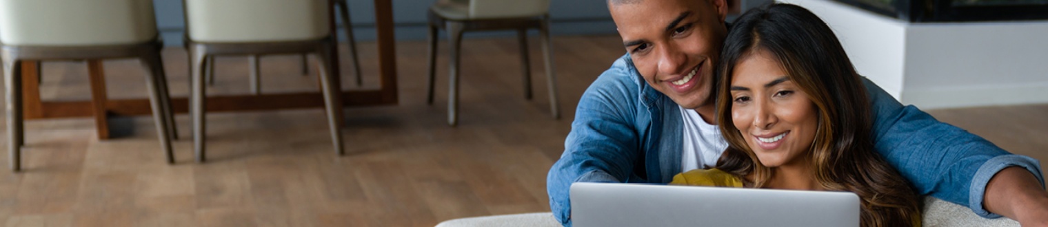 a couple looking at their laptop computer