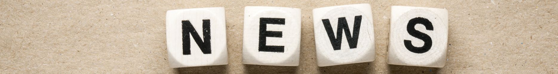 Image of dice spelling the word, 'News'.