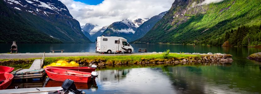 family trip in RV next to mountains and lake.