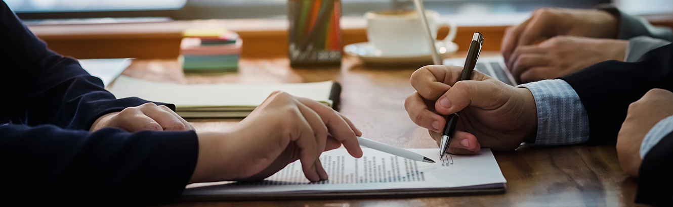 Business people signing a commercial loan