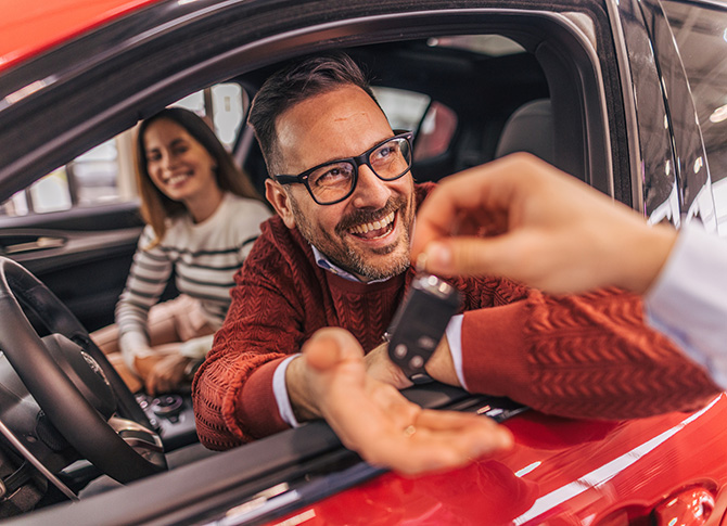 Young couple buying new car