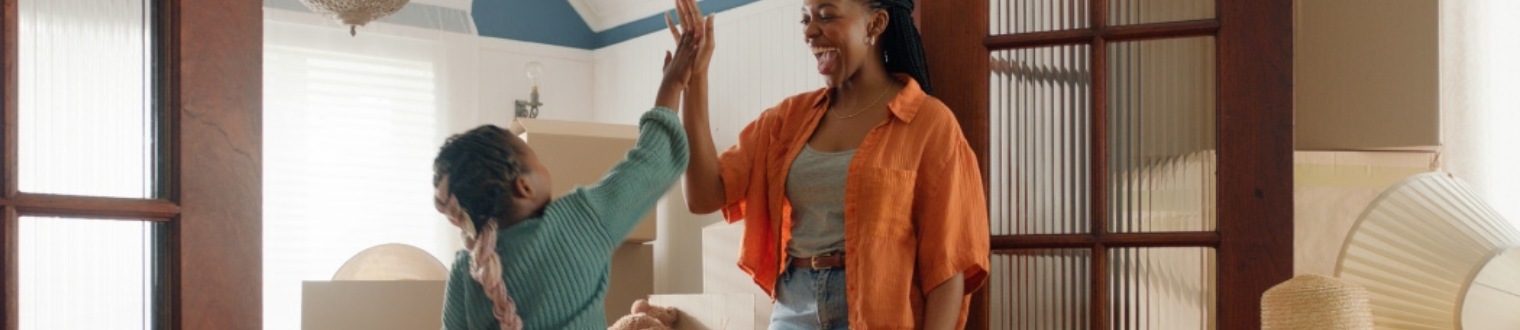 a mother and daughter high-fiving each other.