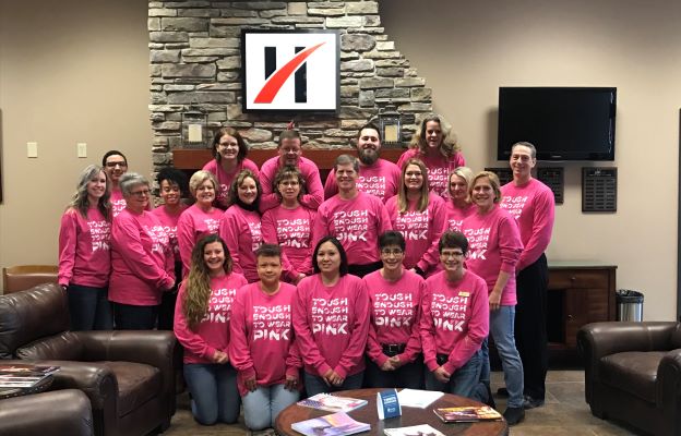 Image of a group of people wearing pink shirts.