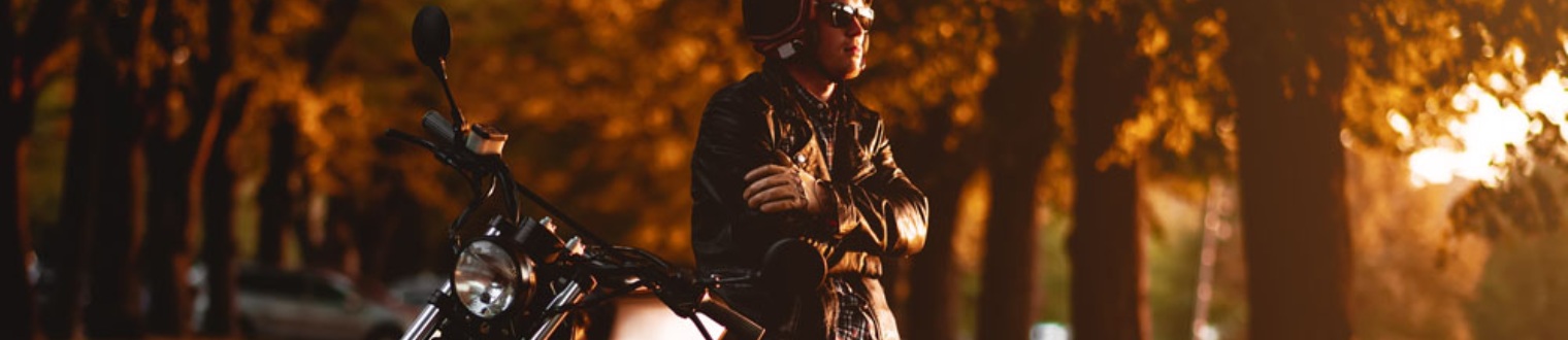 rider leaning on their motorcycle
