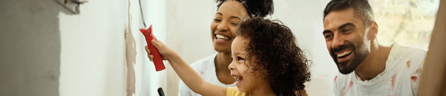 a family painting a wall